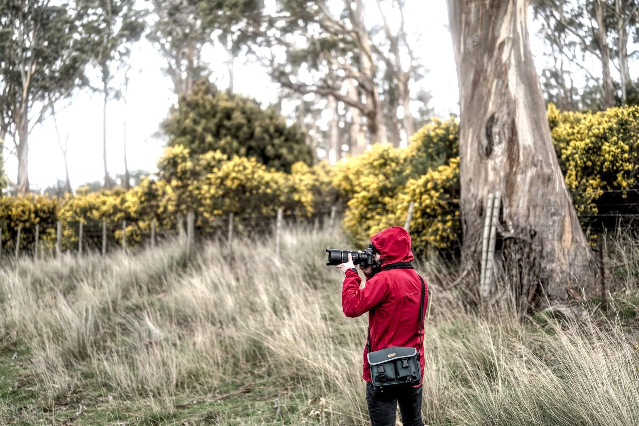 Photo of Jesse Benjamin outdoors taking a photo